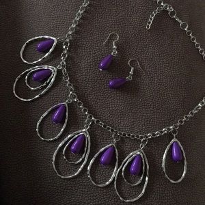 Dangling purple stones from necklace